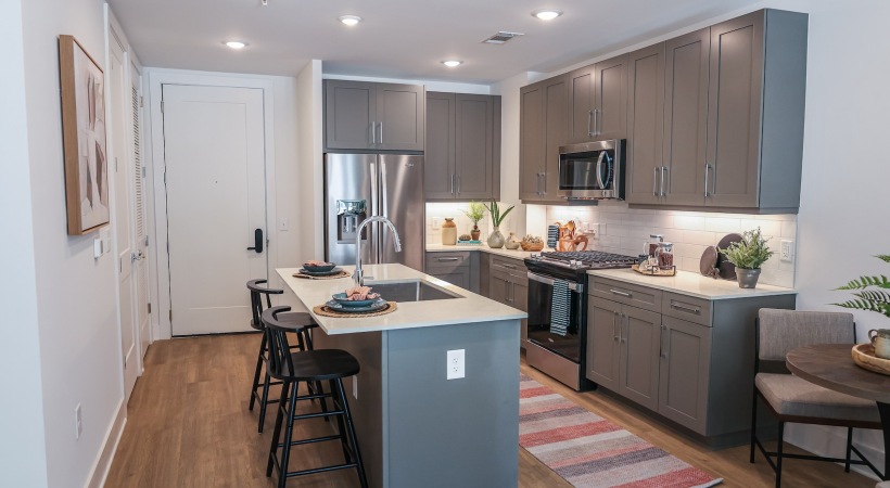 A kitchen with an island and chairs A kitchen with an island and chairs