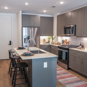 A kitchen with an island and chairs